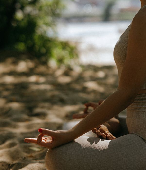 Woman meditating peacefully in a calm environment.